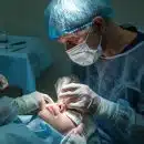 doctor conducting operation at patient in operating room