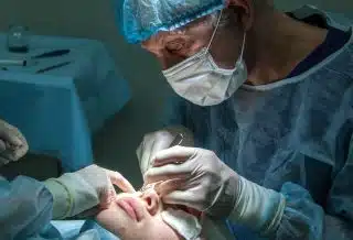 doctor conducting operation at patient in operating room