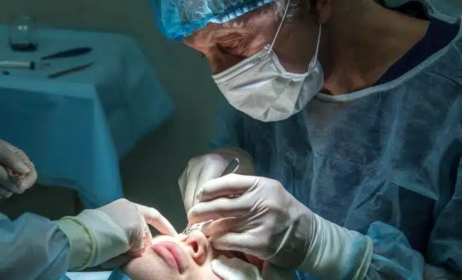 doctor conducting operation at patient in operating room